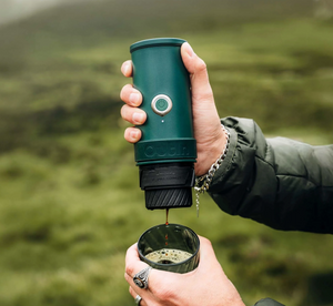 Máquina de espresso portátil de mano en verde cañón con servicio al aire libre de cafeteras portátiles.